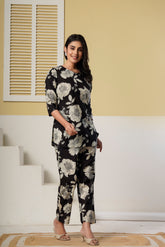 Black floral printed cotton co-ord set featuring a kurti and straight pants by Rouhab, with detailed floral design and comfortable fit.