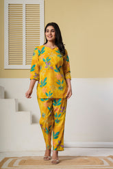 Yellow floral printed cotton co-ord set with kurti and straight pants by Rouhab, showcasing vibrant design and comfortable fabric.