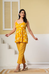 Yellow floral printed cotton co-ord set featuring a spaghetti kurti and straight pants by Rouhab.