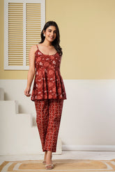Rust red floral printed cotton co-ord set featuring a spaghetti kurti and straight pants by Rouhab.
