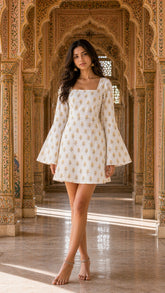 Ivory Rouhab Heritage Flare Dress displayed on a hanger, showcasing its elegant fabric and flowing silhouette.