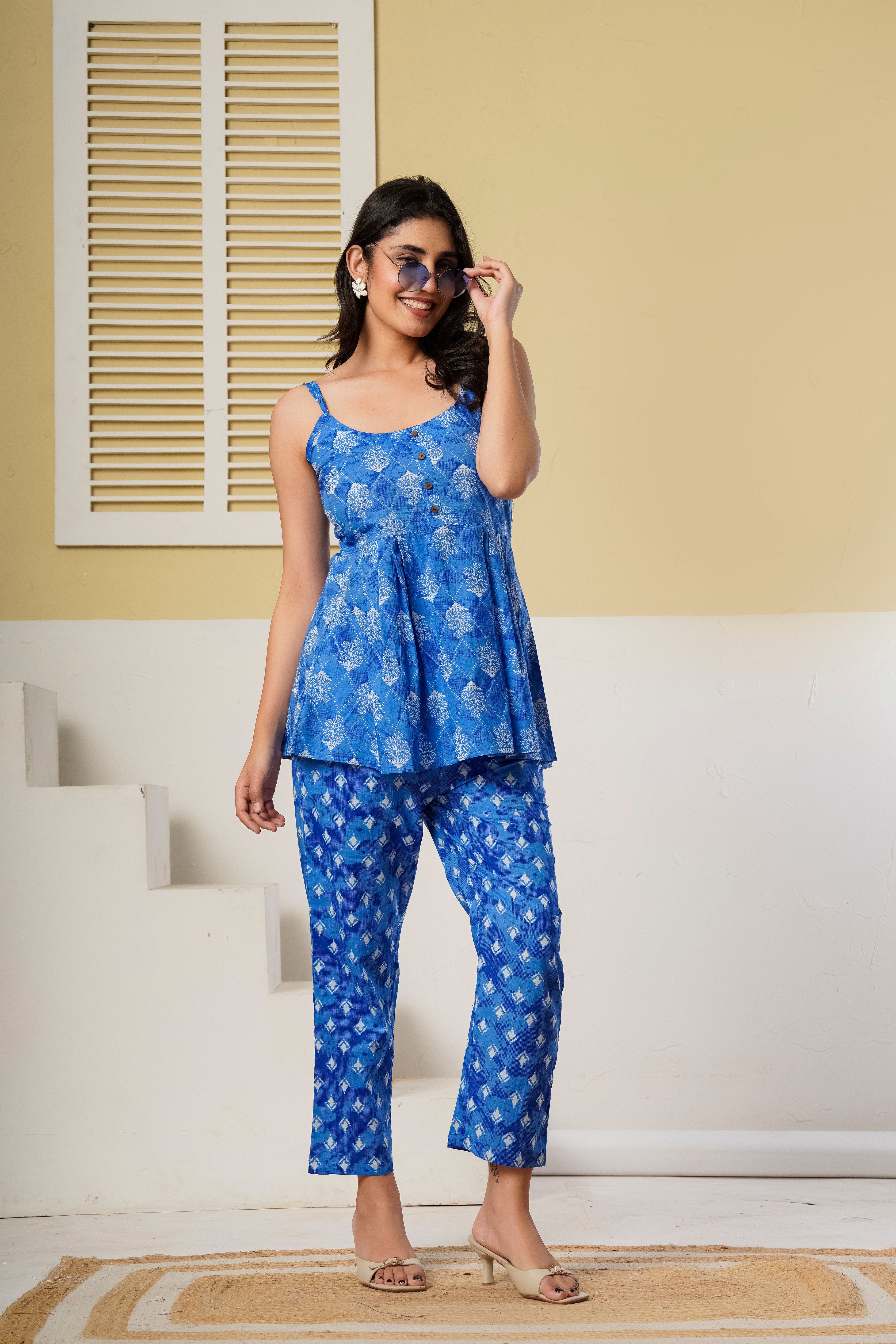 Blue printed cotton co-ord set featuring spaghetti kurti and straight pants by Rouhab, displayed on a hanger.