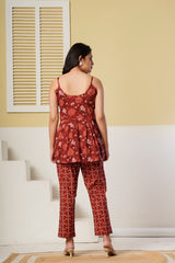 Rust red floral printed cotton co-ord set with spaghetti kurti and straight pants from Rouhab, featuring vibrant floral design.