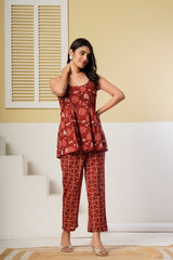 Rust red floral printed cotton co-ord set featuring a spaghetti kurti and straight pants by Rouhab.